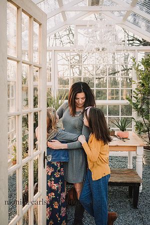 Mother and daughters talking in a greenhouse at Prospect farms