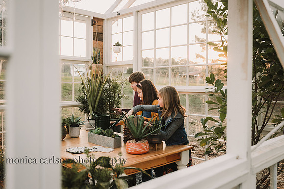 Siblings doing some gardening in a greenhouse
