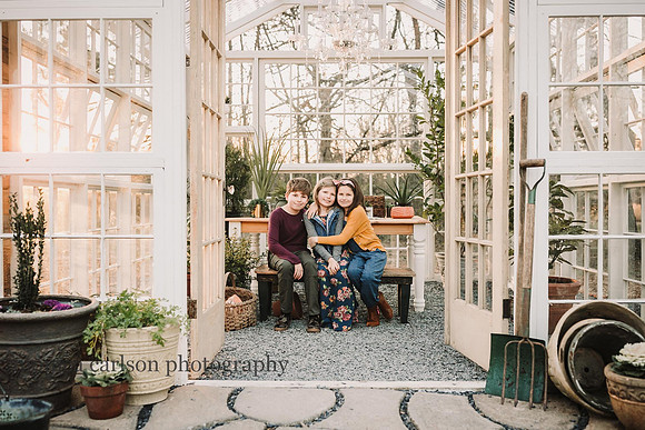 Siblings sitting in a greenhouse at Prospect farms