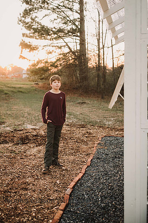 Serious tween boy hanging out at Prospect farms