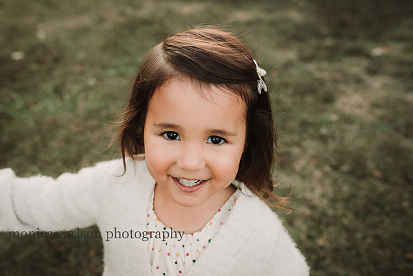happy little girl smiling at the camera in Roswell, Georgia