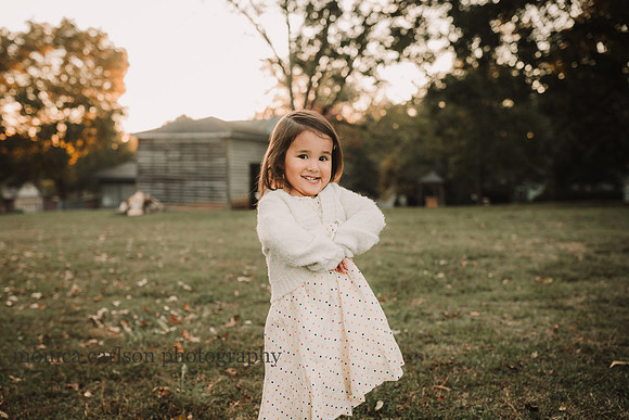 happy little girl with golden light surrounding her