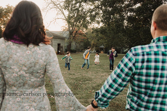 View of four kids running towards their parents during a family photography session