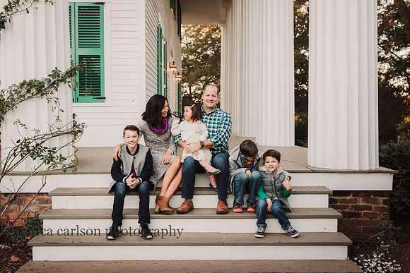 family of six sitting on the steps of Barrington Hall