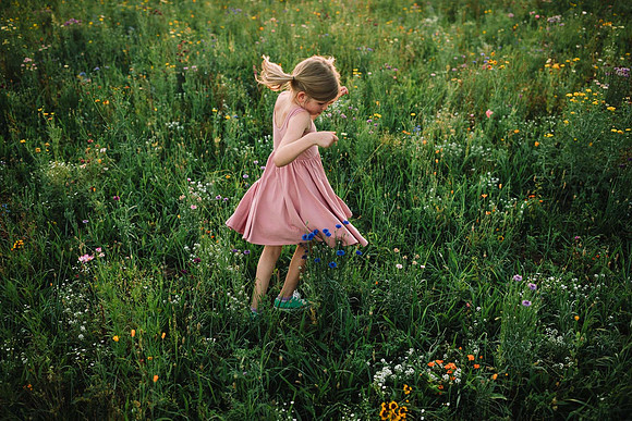 little girl spinning on a wild flower field at Prospect farms