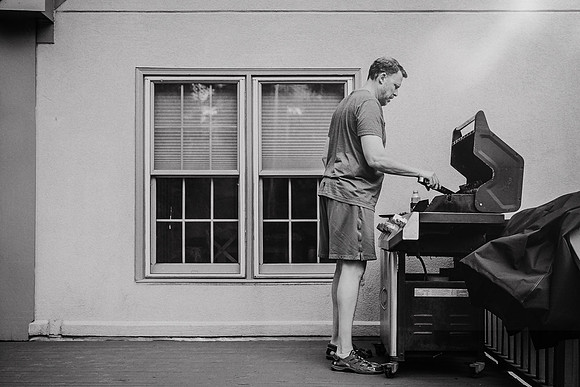 man cooking dinner on a grill