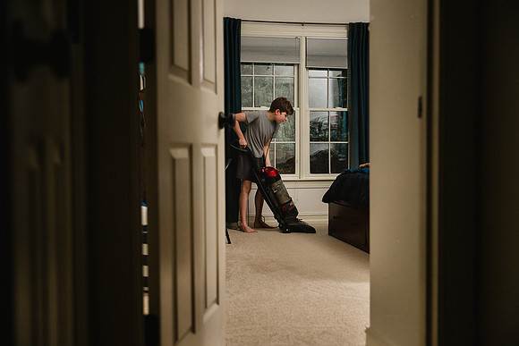 boy vacuuming his room during quarantine chores