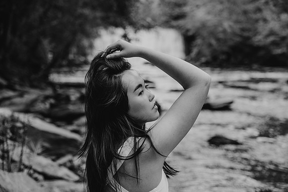 Teen girl in front of a water fall