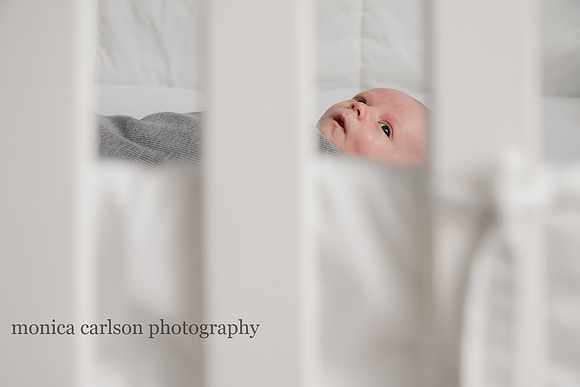 photo of a baby in the crib through the slats