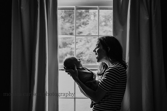 mom enjoying watching her baby yawn