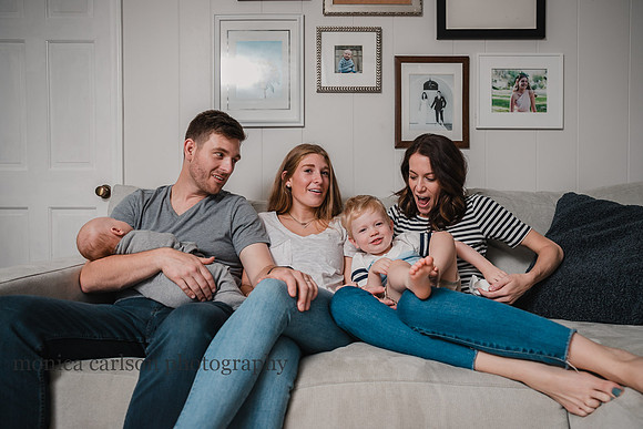 sweet family cuddled on their couch at home