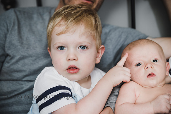 portrait of a toddler and newborn brother
