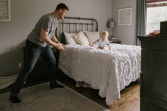 father and son wrestling together happily