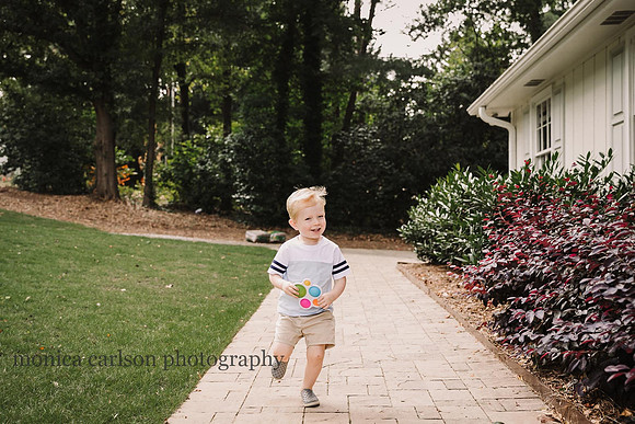 blonde boy running outside his home