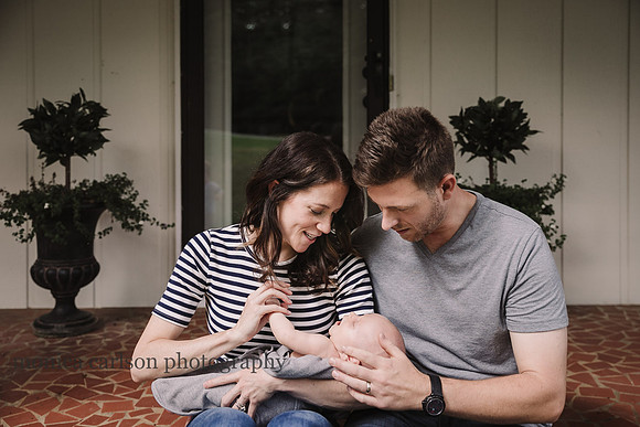 mother and father holding their newborn son