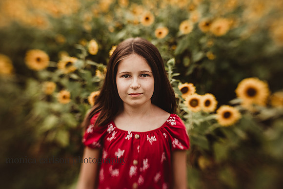 girl in a field of sunflowers by monica carlson