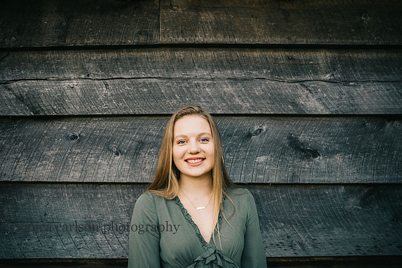 portrait of a teen girl in a front of a barn