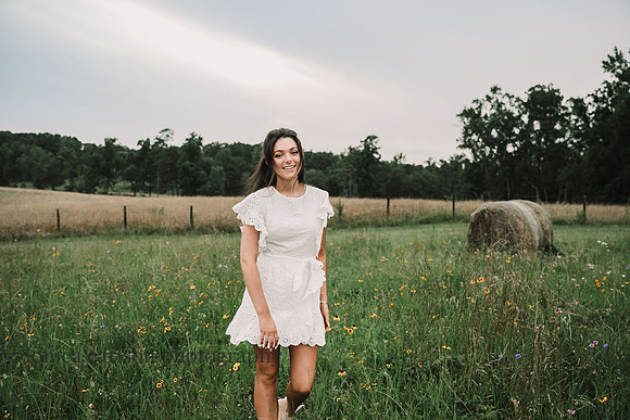 Young woman walks across a wild flower flower field at Prospect Farms