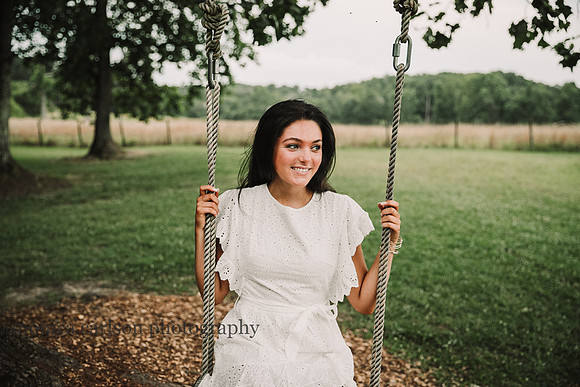teen girl sitting on a swing in at Prospect farms