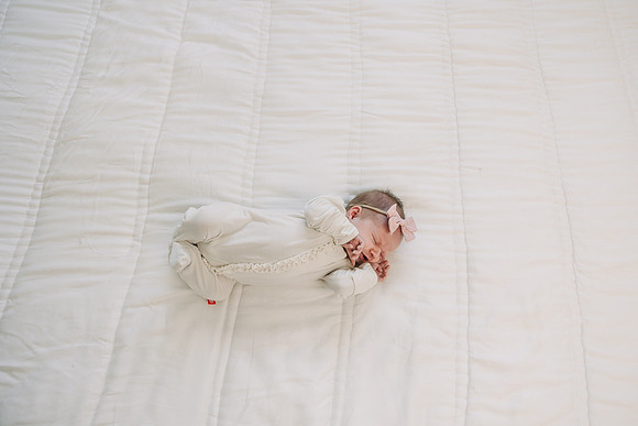 view from above a newborn girl on a bed