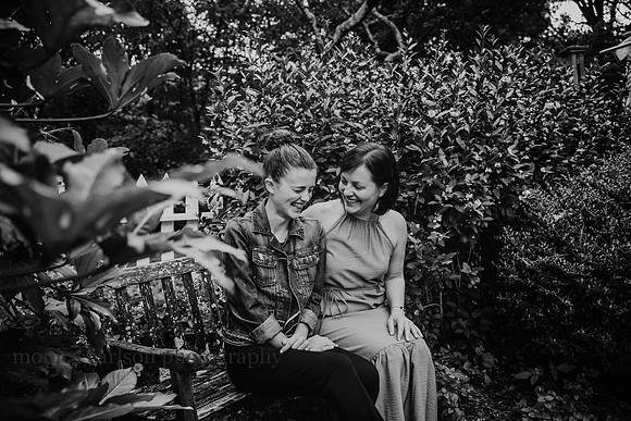 mother and daughter laughing together during a photo session with Monica carlson
