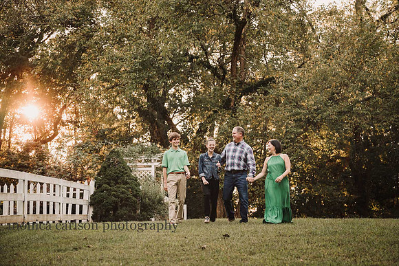 family of four laughing while on a walk at Bulloch hall
