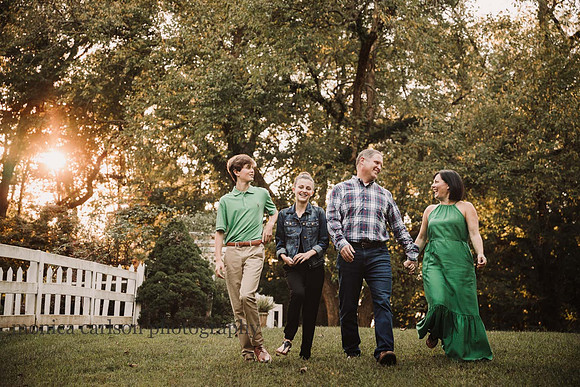 family of four laughing together on a walk with Monica carlson
