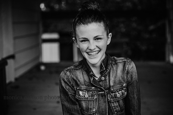 black and white portrait of a happy teen girl by monica carlson photography