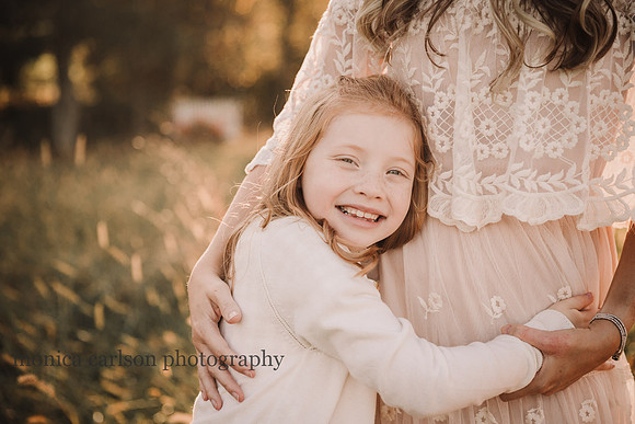 red headed girl happily hugs her mother at Prospect farms