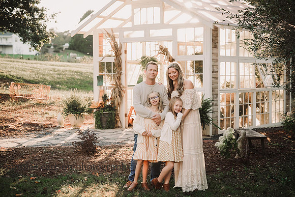 portrait of a family in front of a greenhouse by monica carlson