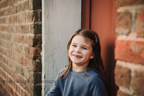 smiling, toothless little girl smiling at someone