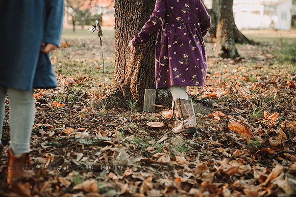 girls walking towards a fairy garden door