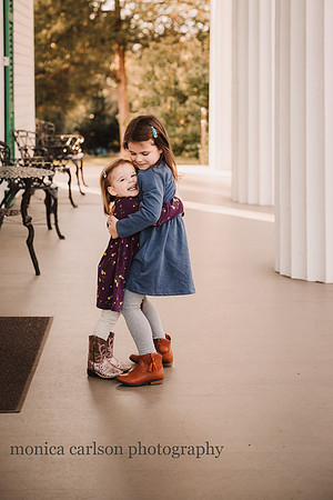 sisters hugging during a family photo session