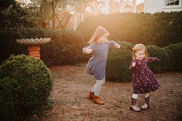 sisters spinning in golden light in Roswell, GA