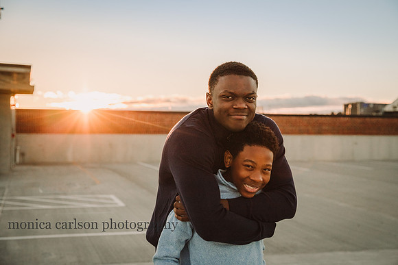 portrait of teen boys bonding at Halcyon Forsyth rooftop parking lot