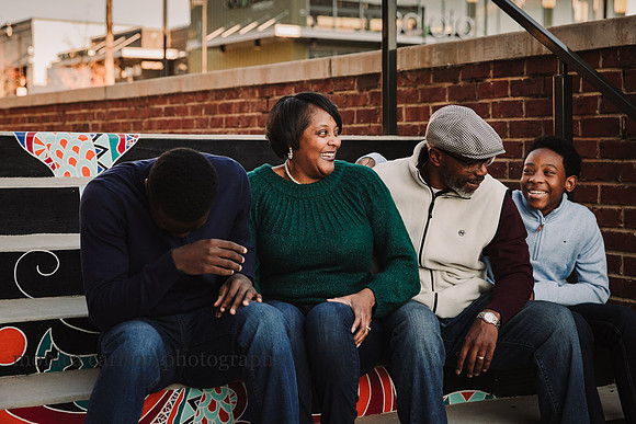 family of for laughing at photo session with monica carlson