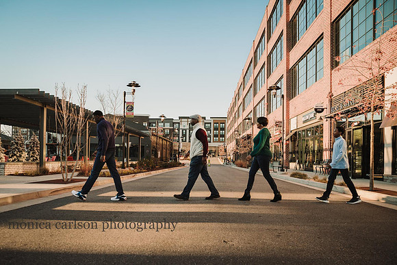 family of four walking across a street like the Beatles Album cover