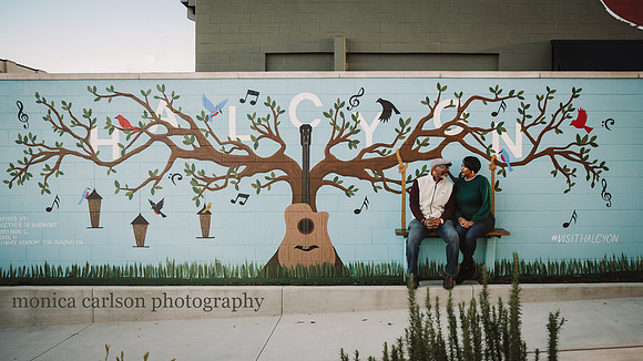 couple siting on a painted swing art during a family photo session