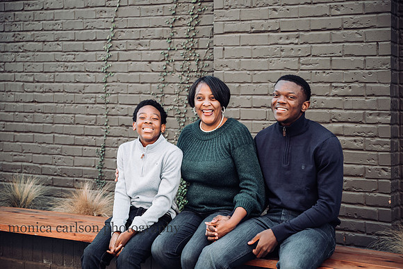 mother laughs with her two teen sons during a family mini session