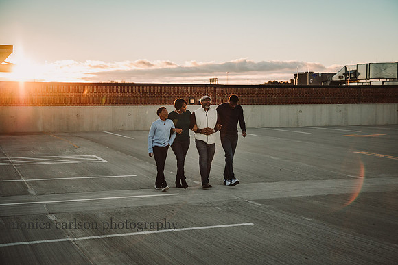 family of four walks together on the roof of a parking lot at Halcyon forsyth