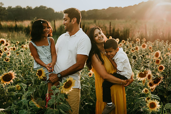 family of four happily love on each other during a photo session by monica carlson photography