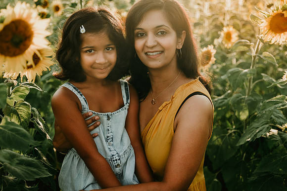 indian mother and elementary age daughter smile for the camera during a photo session at Prospect farms