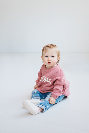 little girl in a pink sweater
