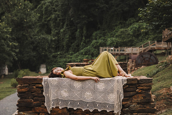 Teen girl laying on a Colum at Roswell Mill