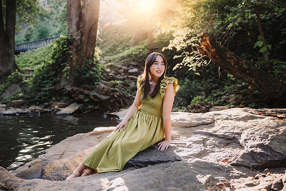 Teen girl sitting on a rock at Vickery Mill