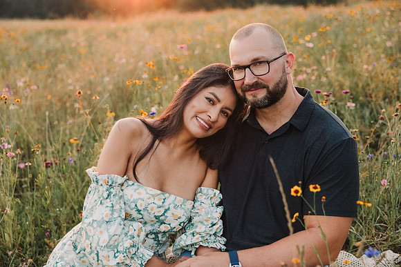 portrait of a couple at sunset on a field