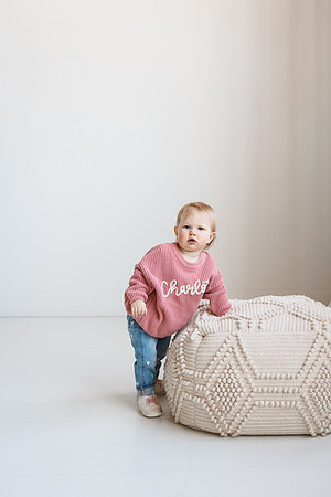 one year old girls stands assisted