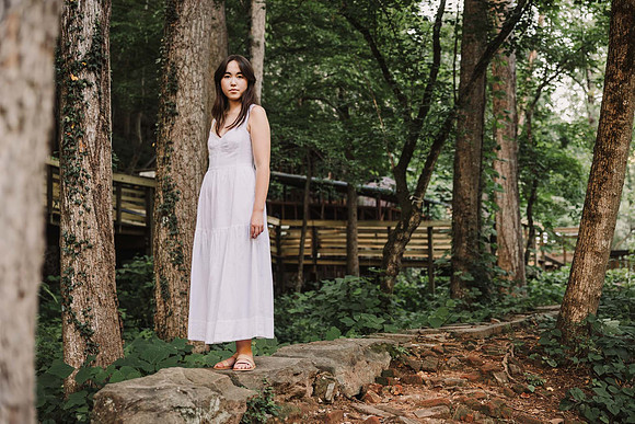 High school senior walking in a wooded area