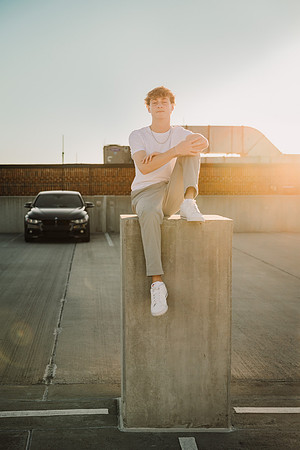 Lambert high school senior on a parking lot roof top at sunset