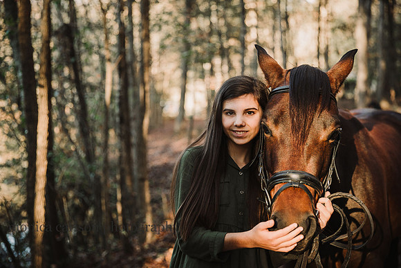 happy girl holds her horses face